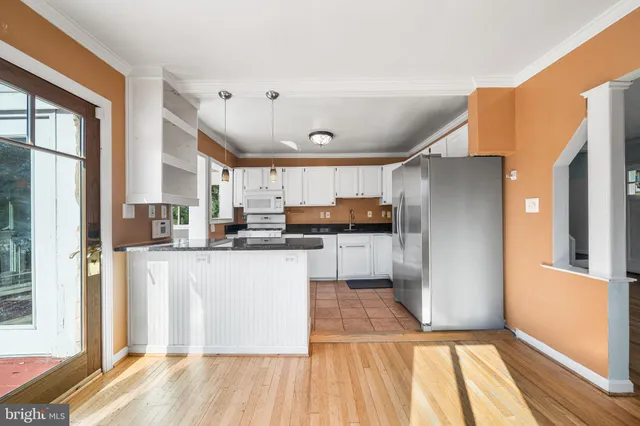 a kitchen with stainless steel appliances a refrigerator and a stove top oven