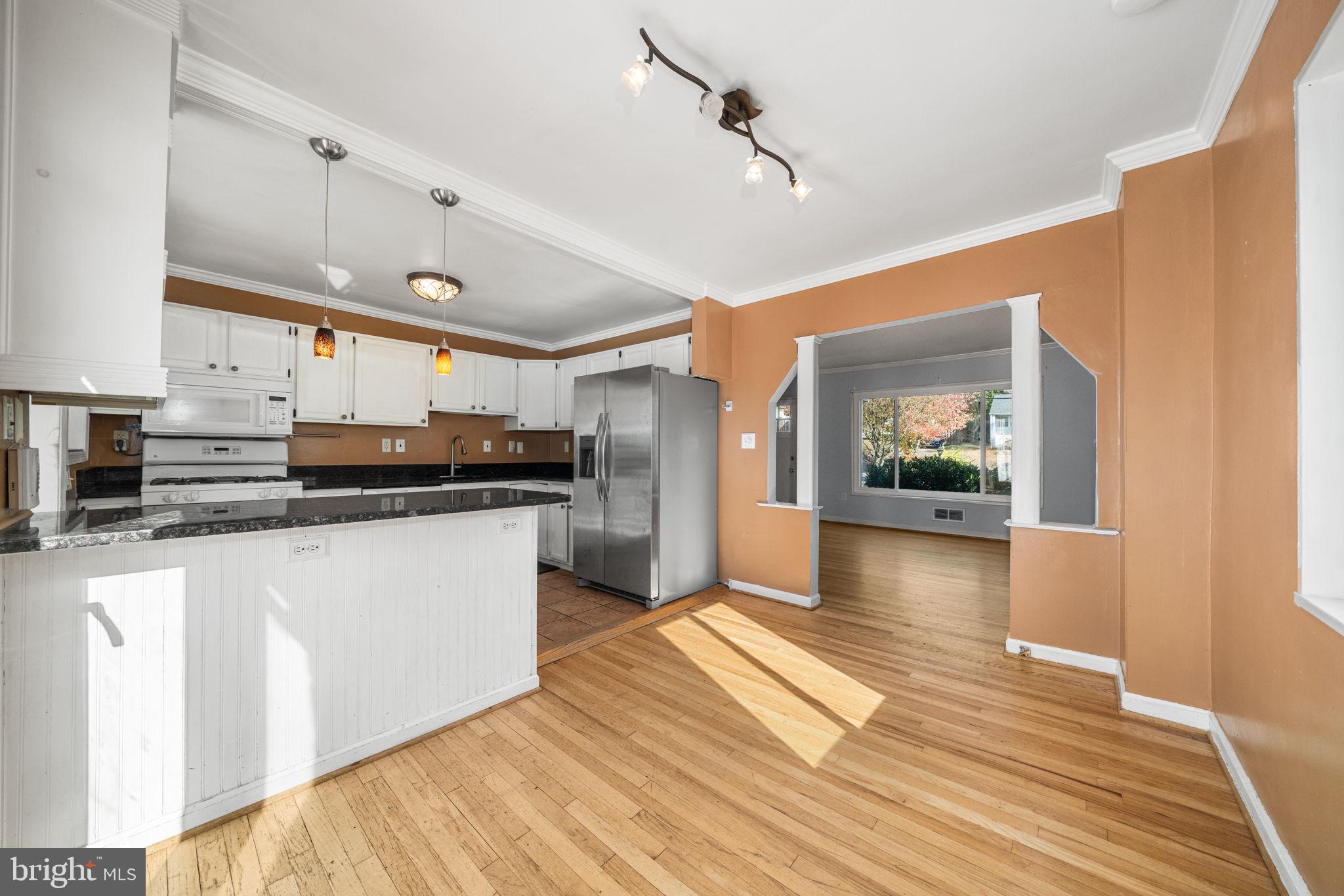3924 Taney Avenue Alexandria, VA 22304 - Photo 14 of 57 a kitchen with stainless steel appliances kitchen island granite countertop a stove a sink and a refrigerator
