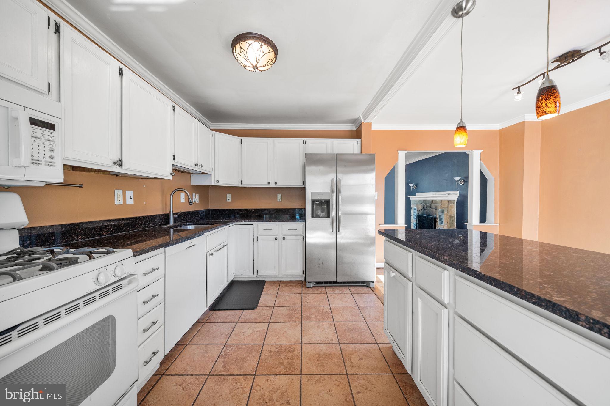 3924 Taney Avenue Alexandria, VA 22304 - Photo 16 of 57 a kitchen with stainless steel appliances kitchen island granite countertop a sink and cabinets
