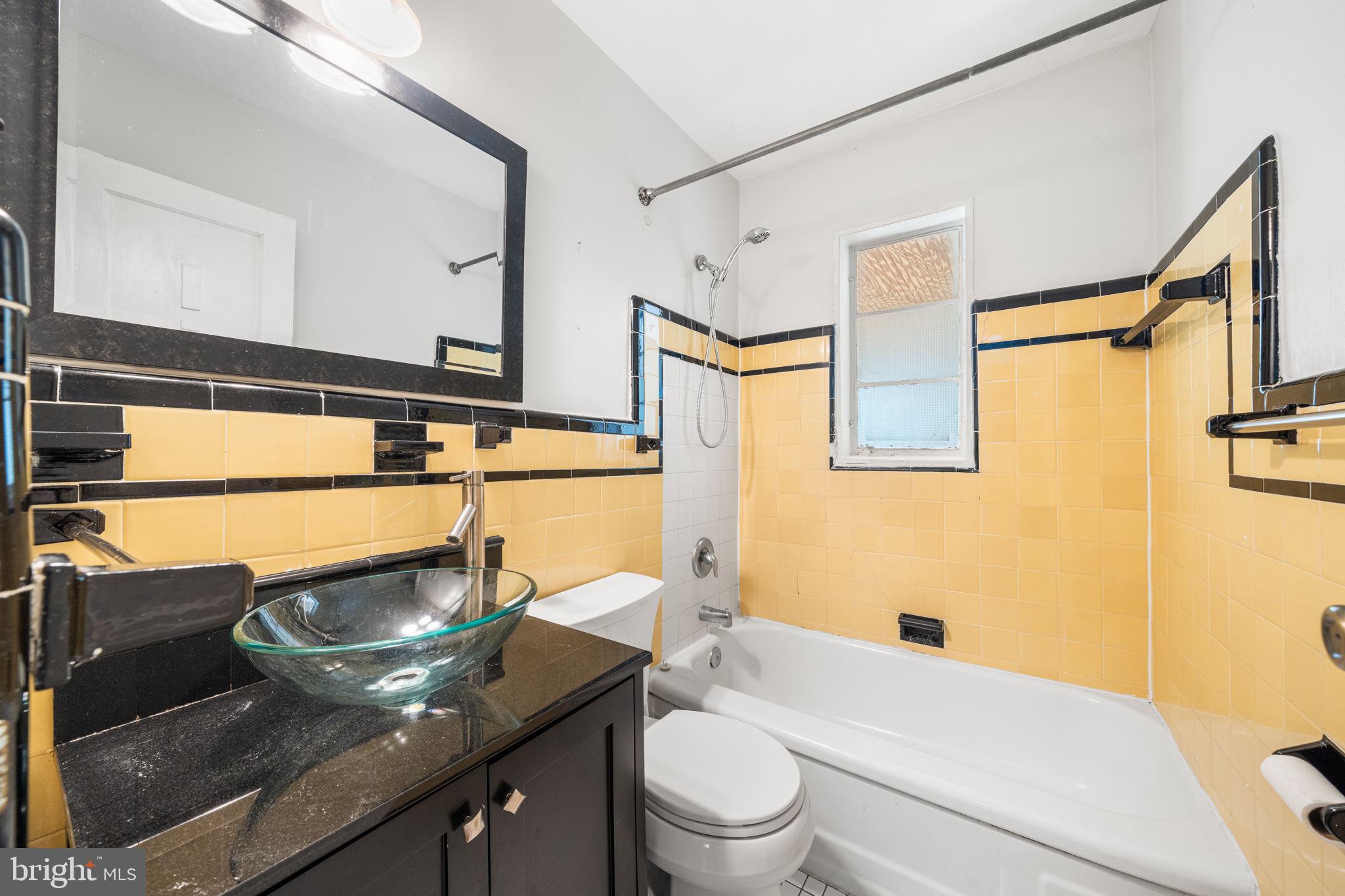 3924 Taney Avenue Alexandria, VA 22304 - Photo 23 of 57 a bathroom with a granite countertop sink mirror vanity and toilet