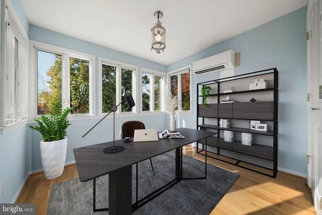 a view of a livingroom with wooden floor and a ceiling fan