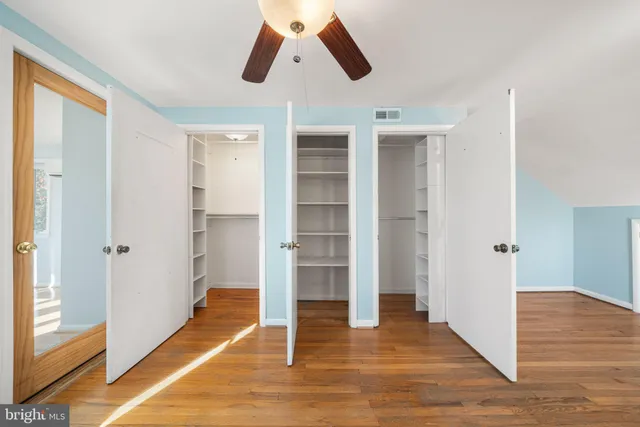 a bedroom with a bed and a potted plant