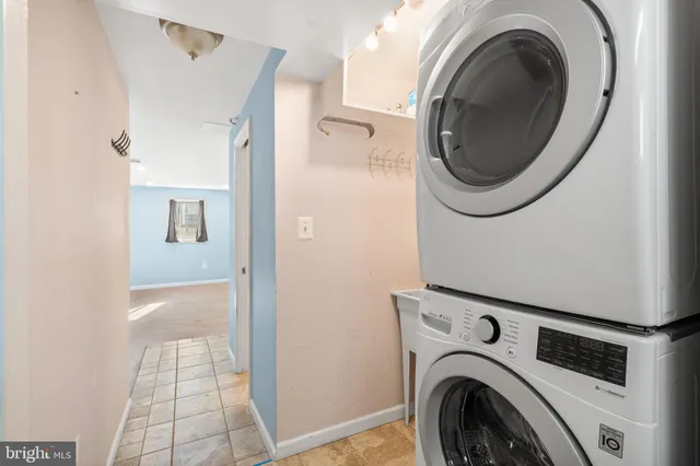 a view of an empty room with wooden floor and cabinet
