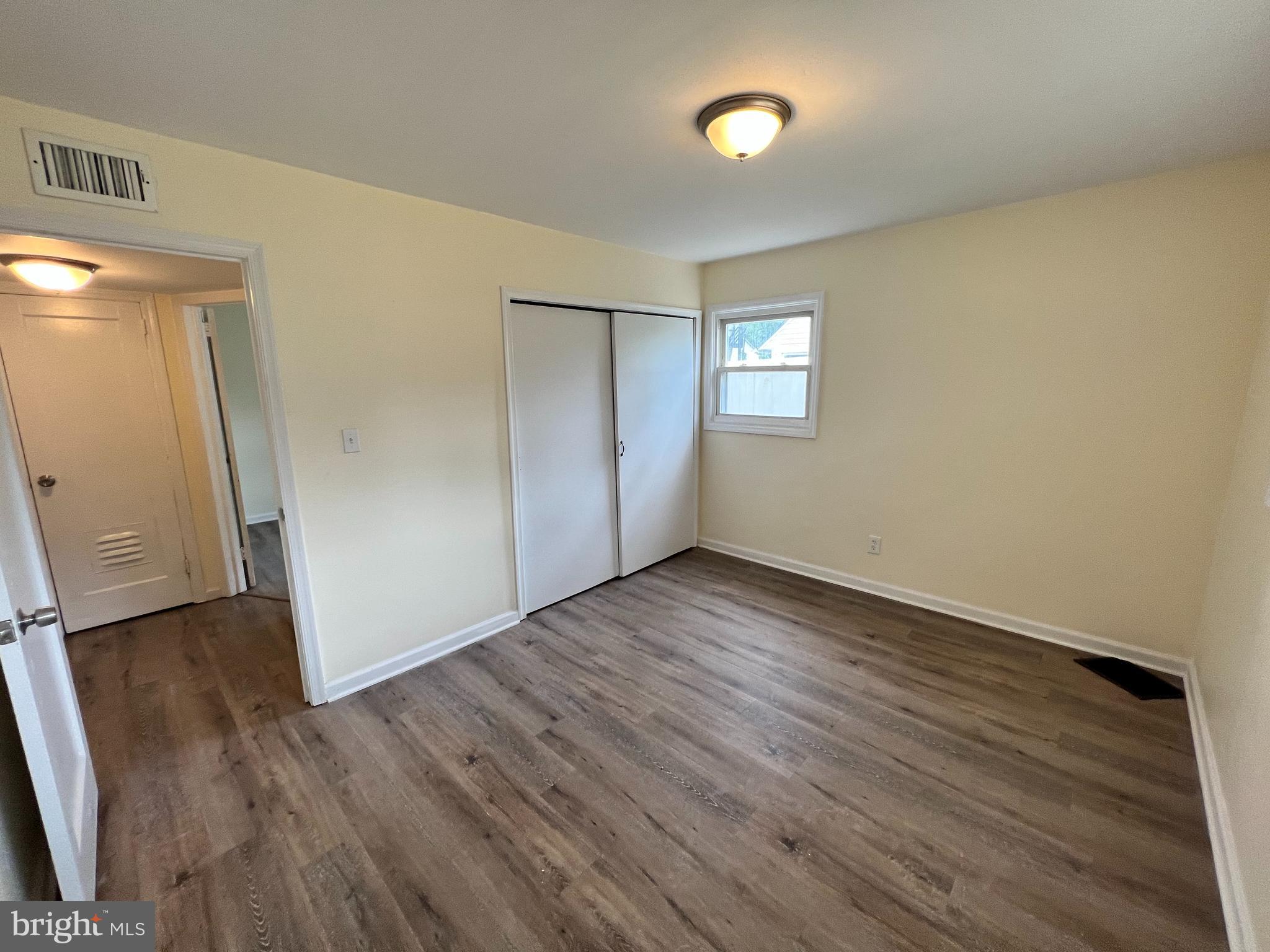 1008 Terrace Boulevard Trenton, NJ 08618 - Photo 11 of 18 an empty room with wooden floor and windows