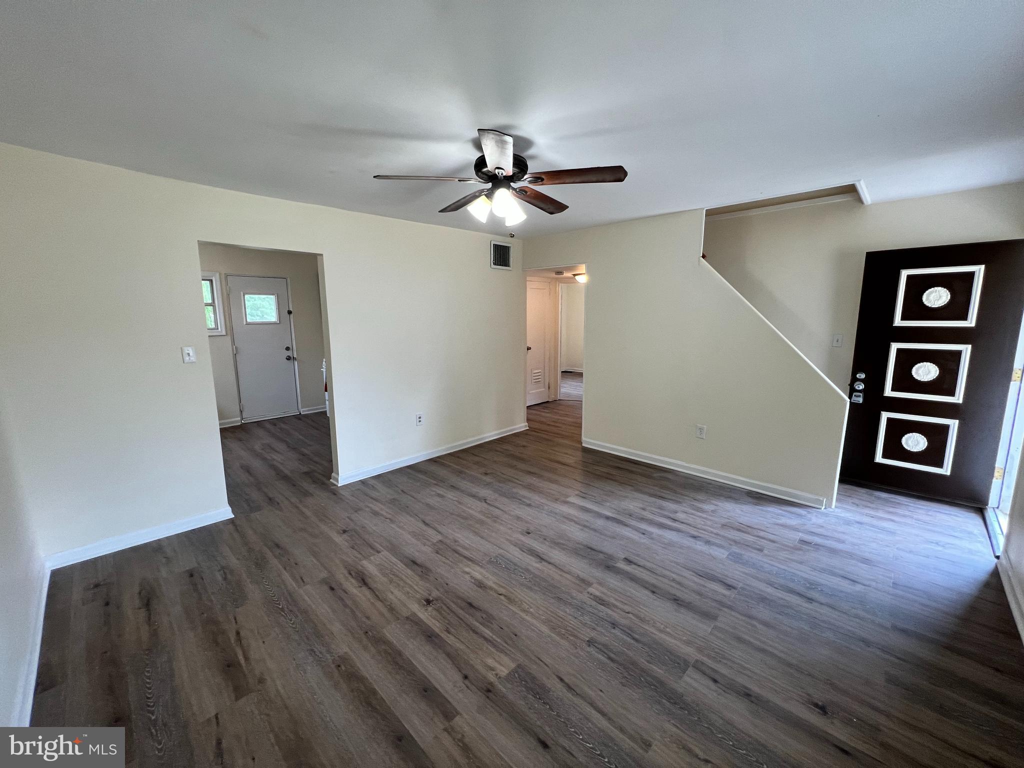 1008 Terrace Boulevard Trenton, NJ 08618 - Photo 4 of 18 an empty room with wooden floor chandelier fan and windows