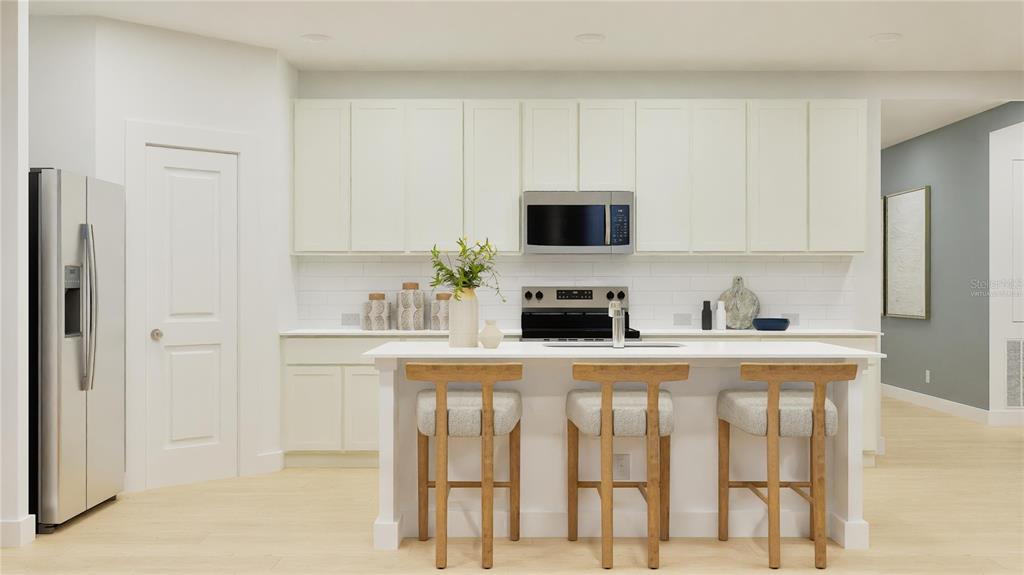 5513 Morant Bay Path Kissimmee, FL 34758 - Photo 2 of 32 a kitchen with stainless steel appliances a stove a sink and a refrigerator