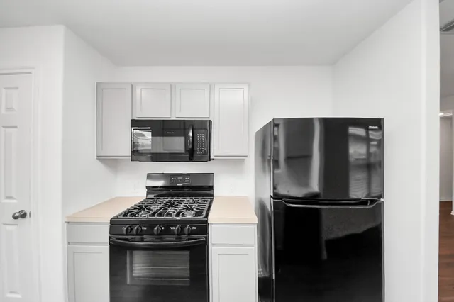 a kitchen with a stove and a refrigerator