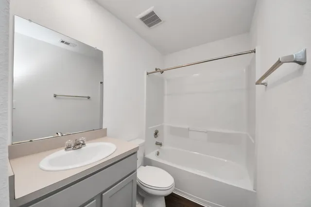a bathroom with a sink a toilet and a bathtub