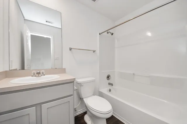 a bathroom with a sink toilet vanity and shower