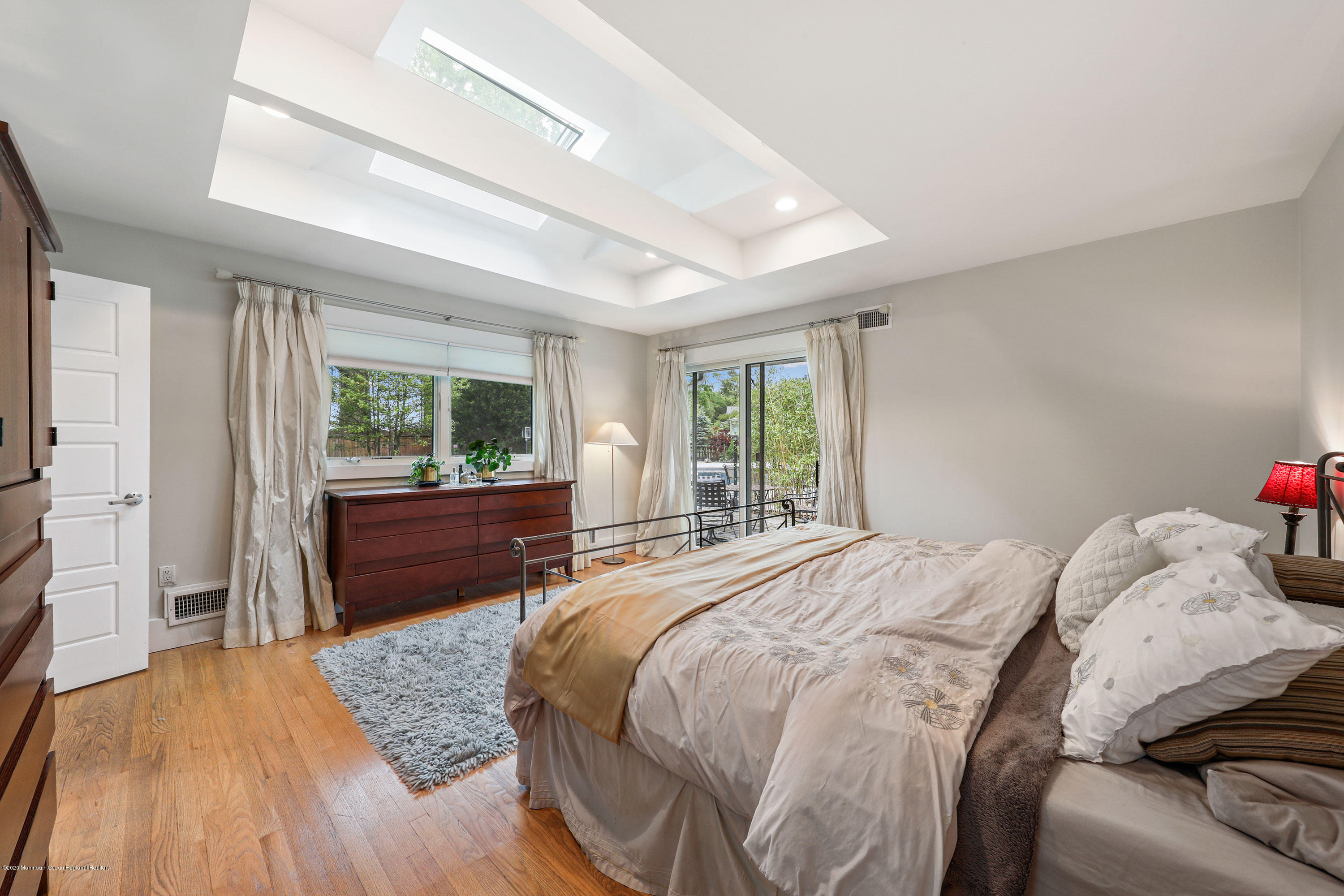 8 Riverside Drive Rumson, NJ 07760 - Photo 15 of 29 a spacious bedroom with a bed and wooden floor