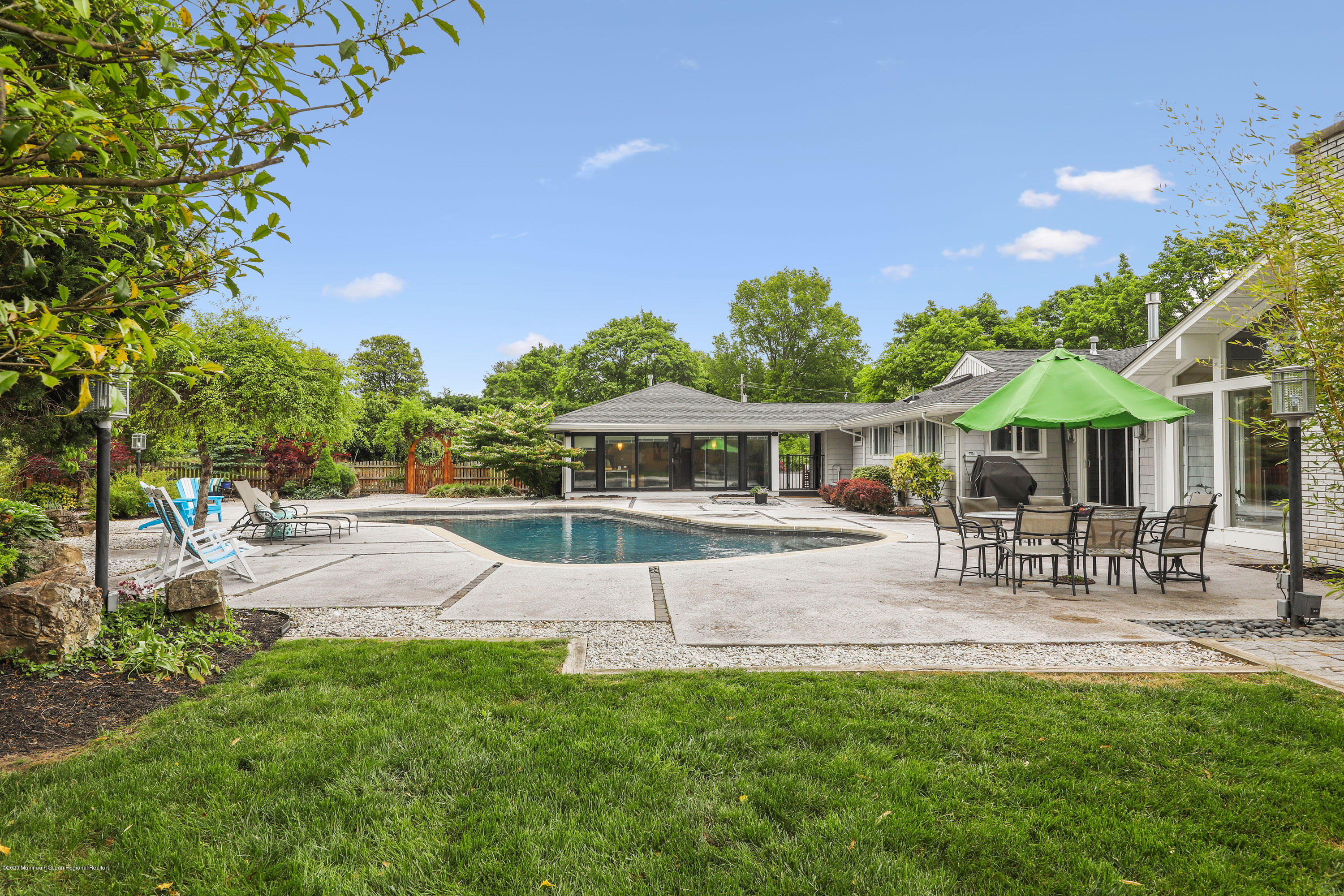 8 Riverside Drive Rumson, NJ 07760 - Photo 3 of 29 a view of patio with table and chairs under an umbrella