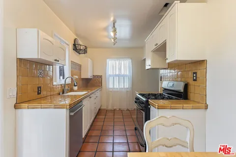 a view of a room with wooden floor and windows
