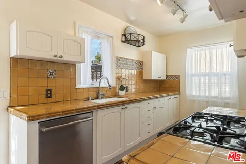 a kitchen with a refrigerator and a stove