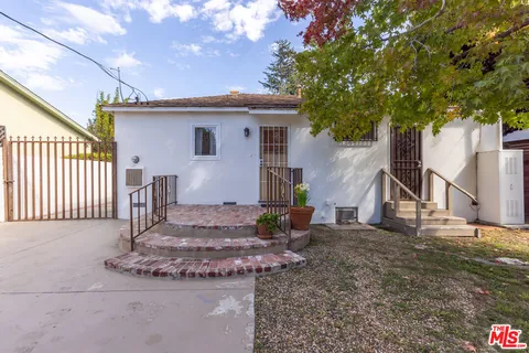 a backyard of a house with outdoor seating
