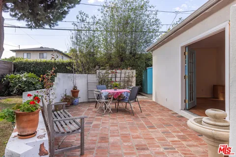 a view of a dining room with furniture a chandelier and wooden floor