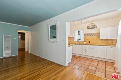 a view of kitchen with granite countertop cabinets and wooden floor