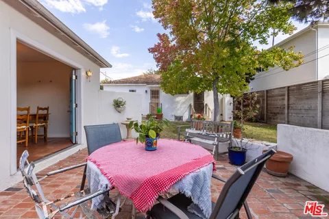 a view of a backyard with plants and a patio