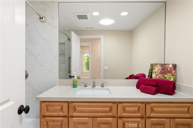 a bathroom with a sink vanity and a mirror