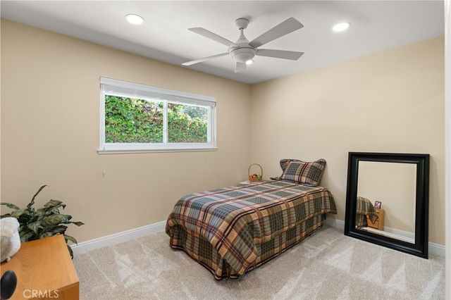 a bed sitting in a bedroom next to a window