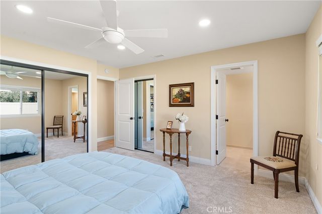 a spacious bedroom with a bed and a lamp