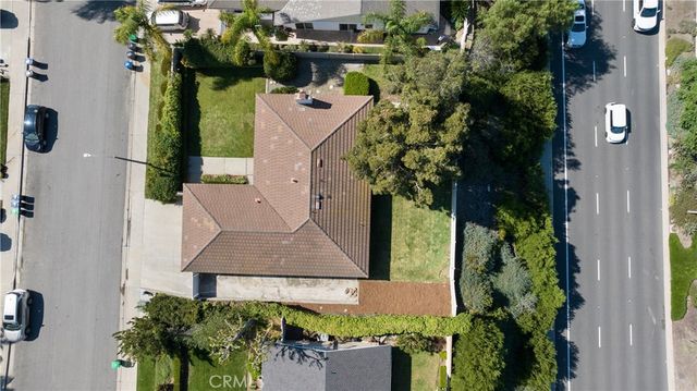 an aerial view of a house with a yard