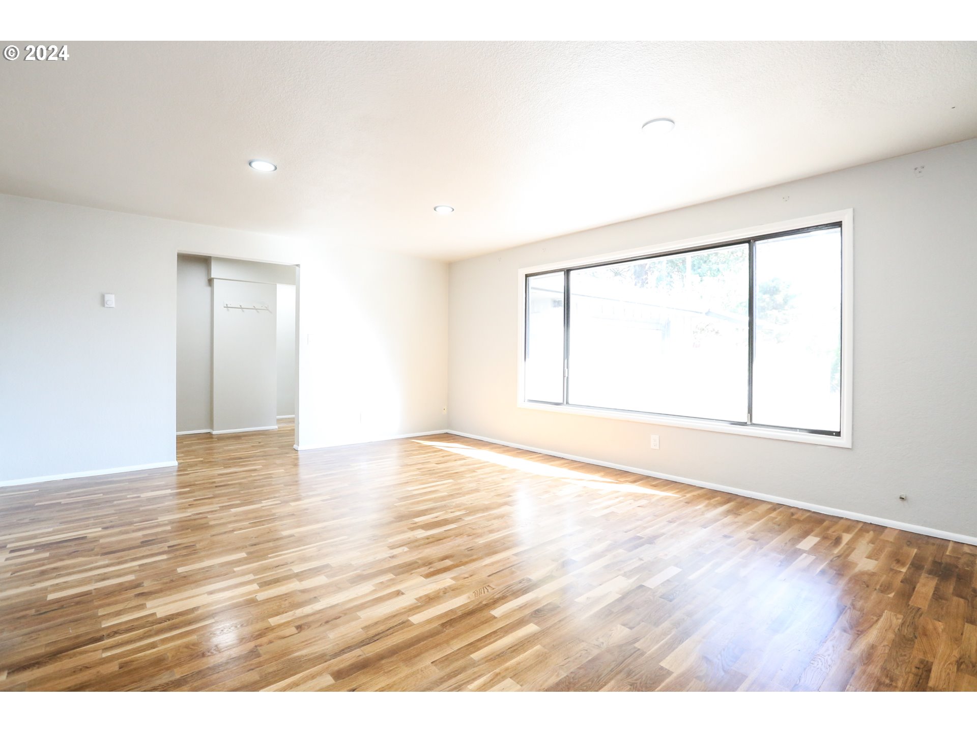 805 Kelly Lane Eugene, OR 97404 - Photo 12 of 31 a view of an empty room with wooden floor and a window