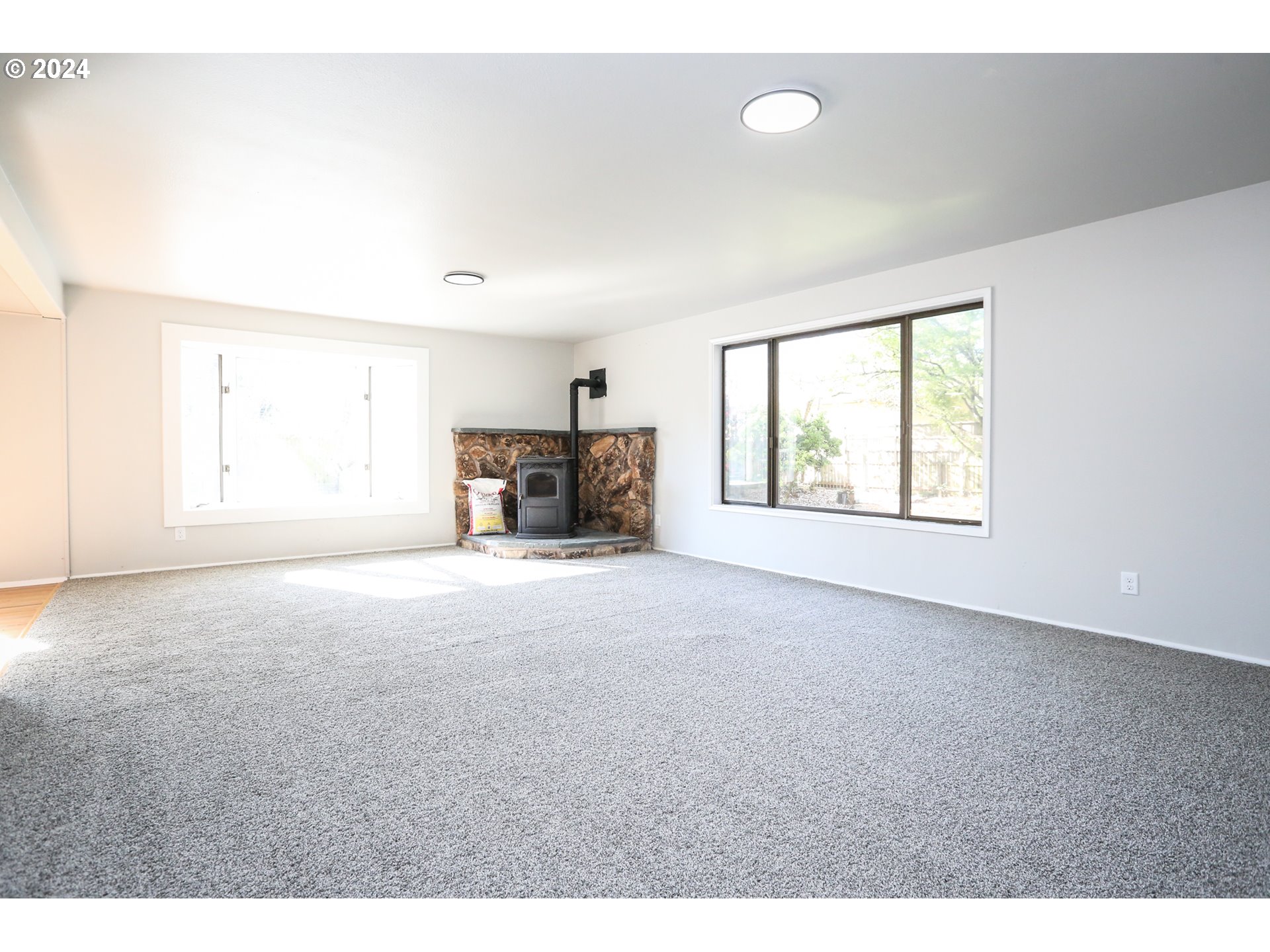 805 Kelly Lane Eugene, OR 97404 - Photo 15 of 31 a view of empty room with fireplace and windows