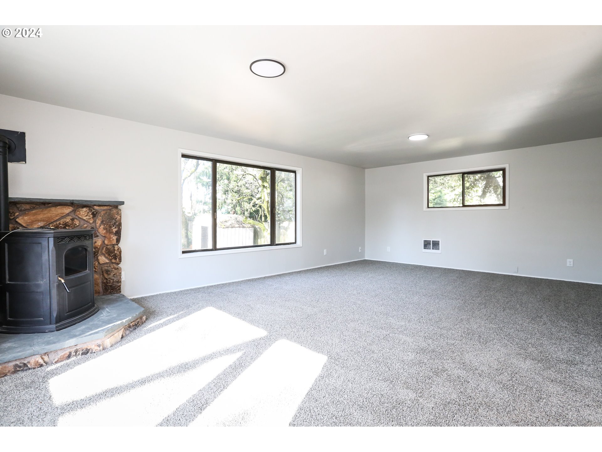 805 Kelly Lane Eugene, OR 97404 - Photo 16 of 31 a view of an empty room with a window and fireplace