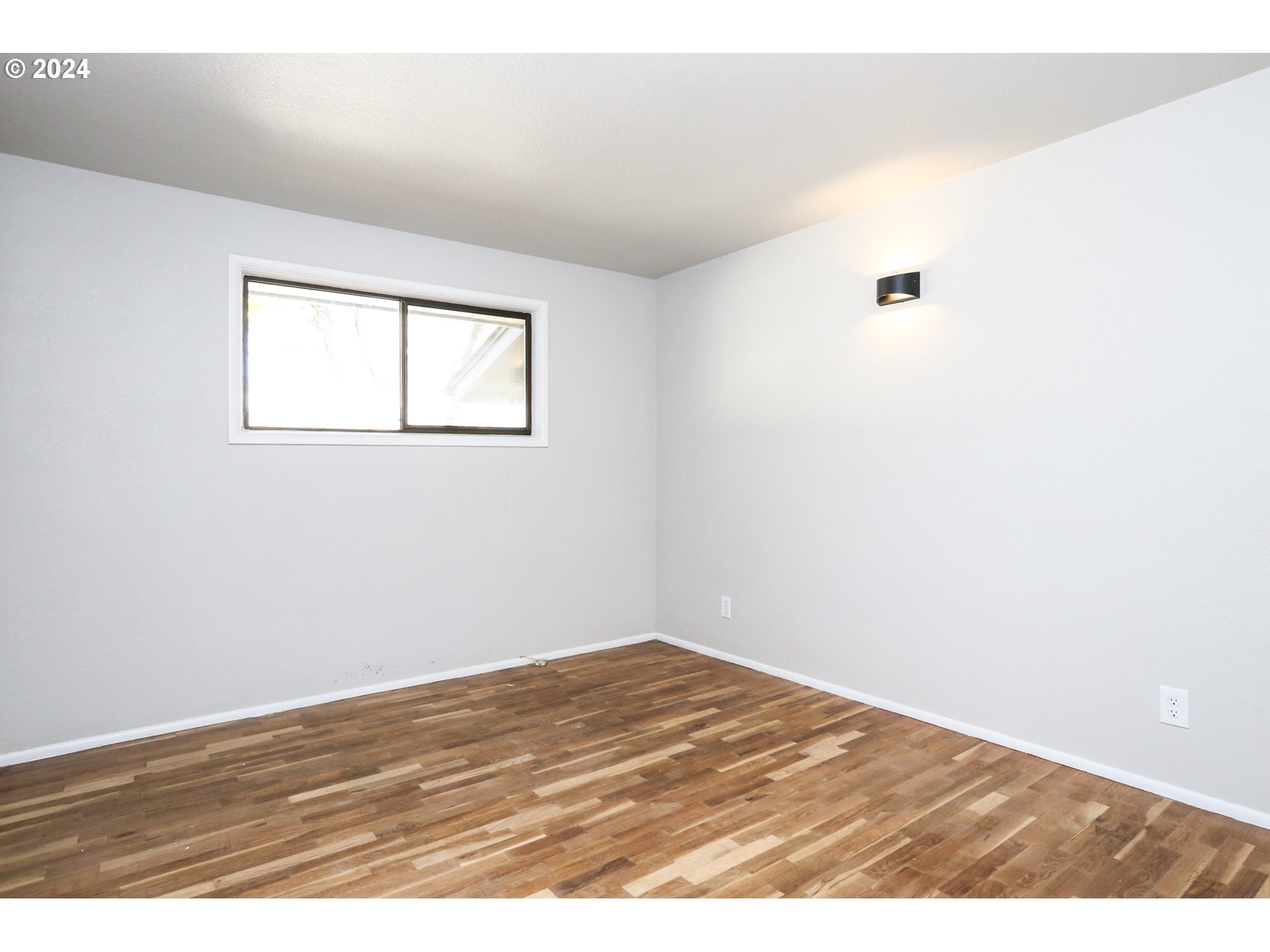 805 Kelly Lane Eugene, OR 97404 - Photo 18 of 31 an empty room with wooden floor and windows