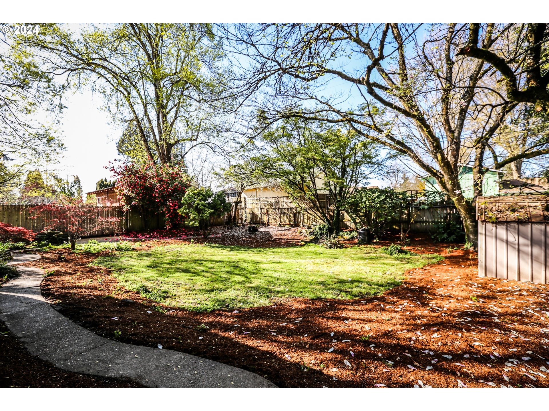805 Kelly Lane Eugene, OR 97404 - Photo 29 of 31 a backyard of a house with a yard and large trees