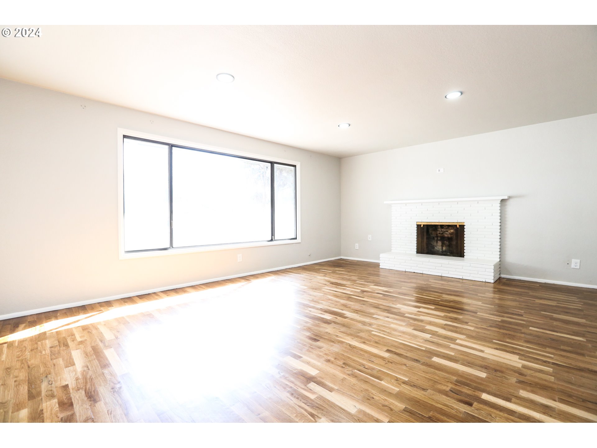 805 Kelly Lane Eugene, OR 97404 - Photo 3 of 31 a view of an empty room with wooden floor and a window