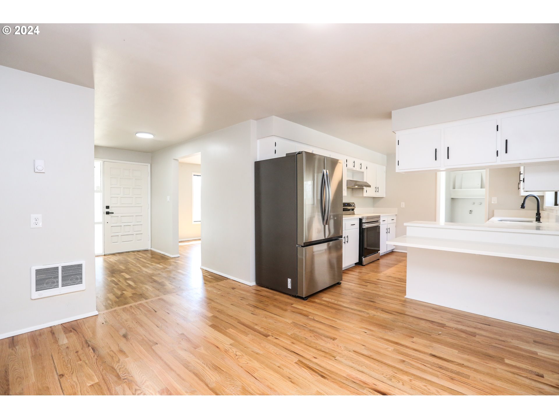 805 Kelly Lane Eugene, OR 97404 - Photo 7 of 31 a kitchen with stainless steel appliances a refrigerator and a sink