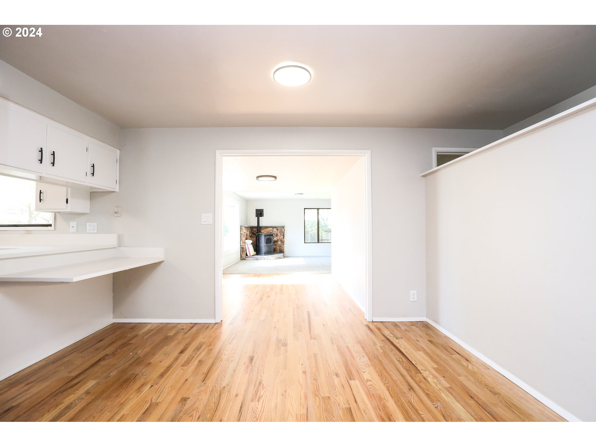 805 Kelly Lane Eugene, OR 97404 - Photo 9 of 31 a open kitchen with cabinets wooden floor and a sink