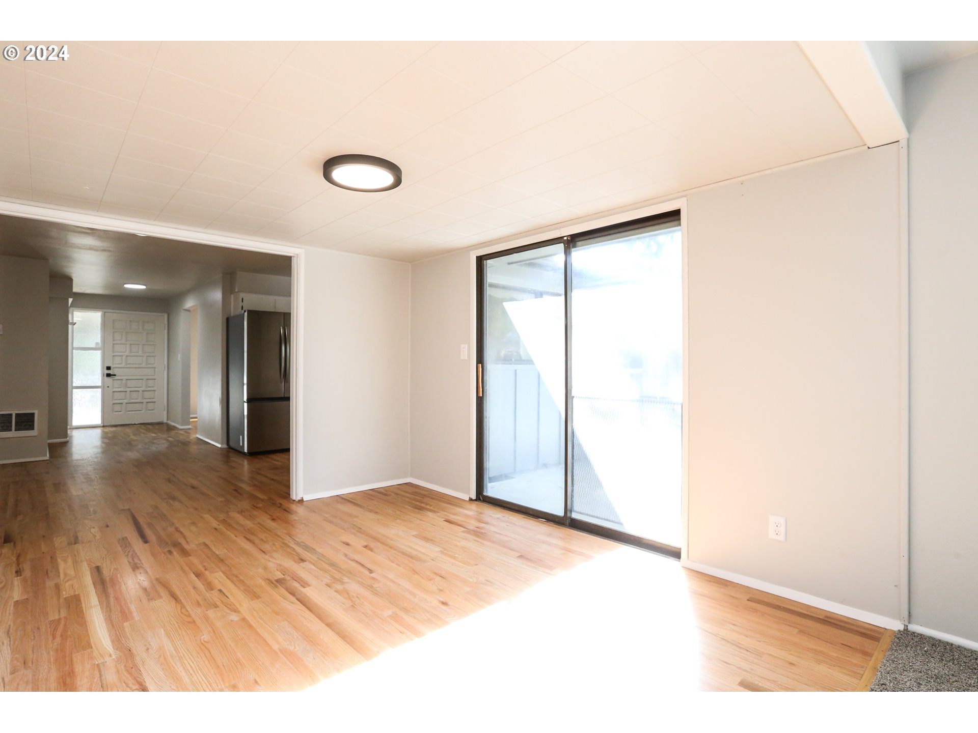 805 Kelly Lane Eugene, OR 97404 - Photo 10 of 31 a view of an empty room with wooden floor