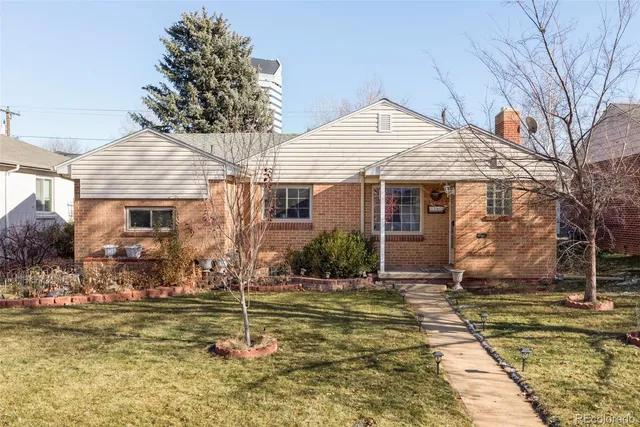 a front view of house with a garden