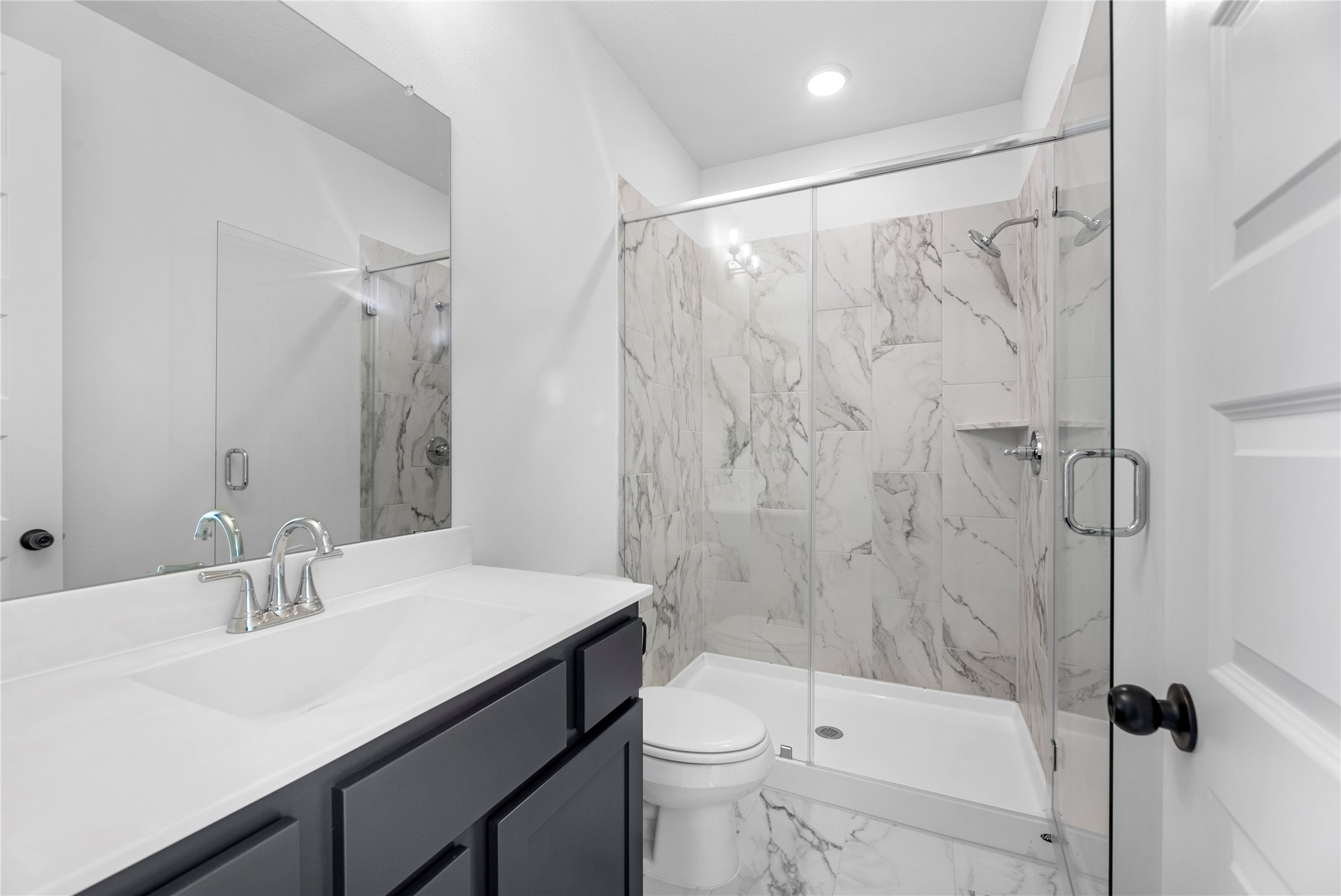 615 Roland Lane Rosenberg, TX 77471 - Photo 14 of 26 a bathroom with a sink a toilet and a mirror