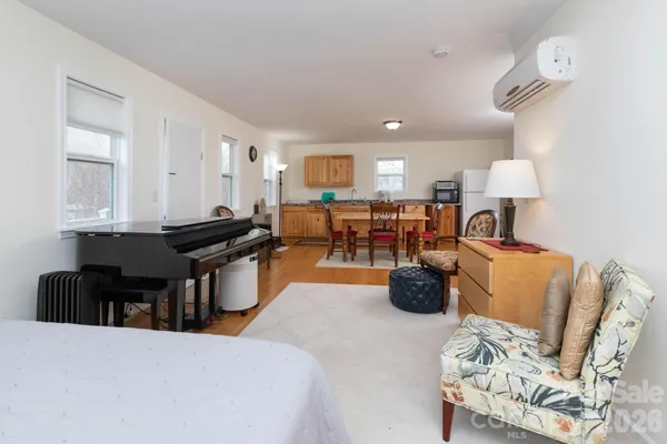 a living room with furniture and wooden floor