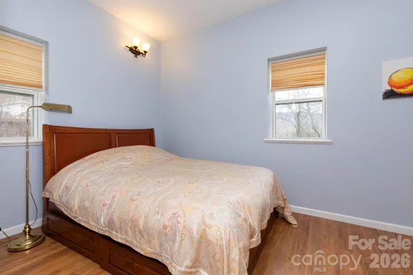 a large bed sitting in a bedroom next to a window