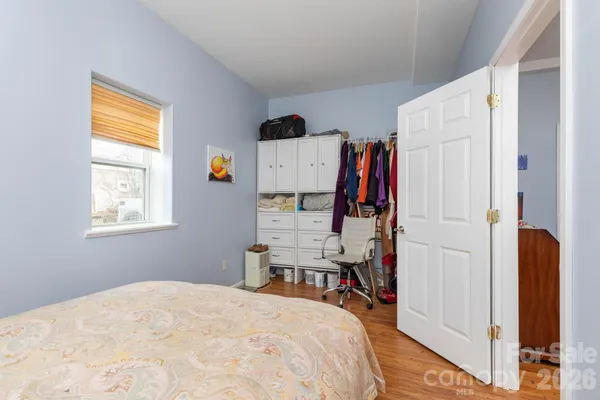 a bed room with a bed and a window