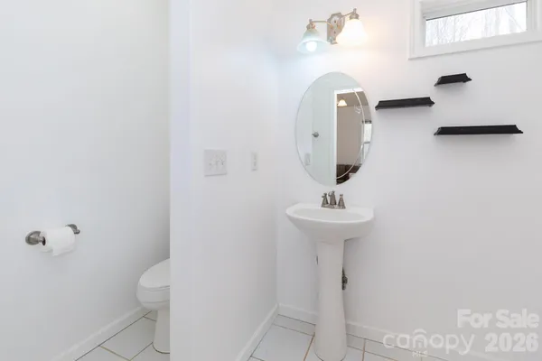 a bathroom with a sink a toilet and mirror