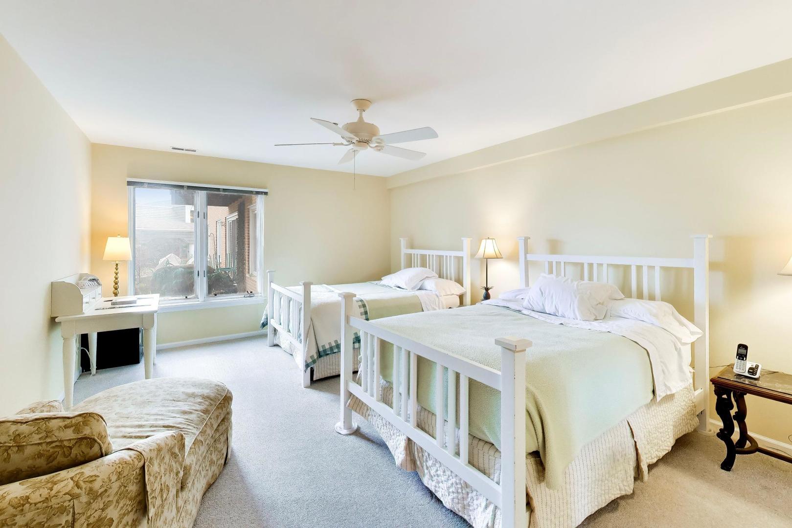 308 North Happ Road, Unit 108 Northfield, IL 60093 - Photo 17 of 31 a spacious bedroom with a bed a couch and a chandelier