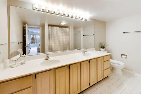 a bathroom with a double vanity sink and a mirror