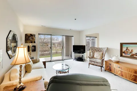 a living room with furniture a large window and a flat screen tv