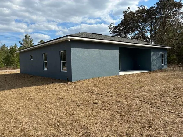 a backyard of a house with garage