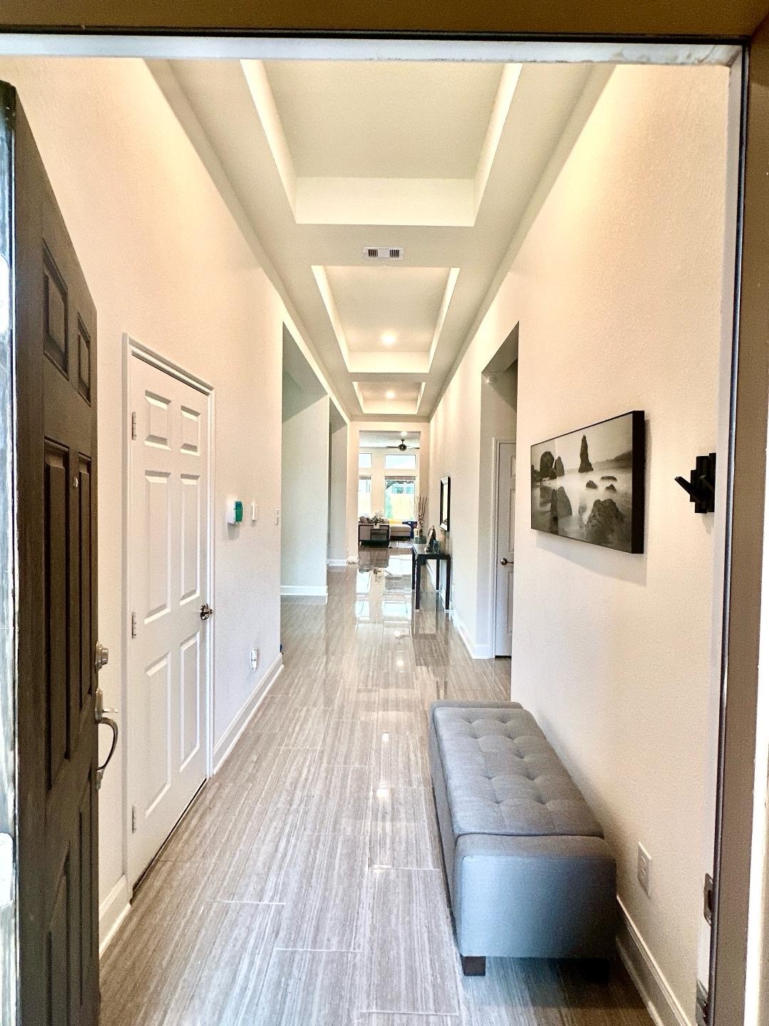 1110 Penny Ranch Lane Katy, TX 77494 - Photo 4 of 31 a view of a hallway with wooden floor and furniture