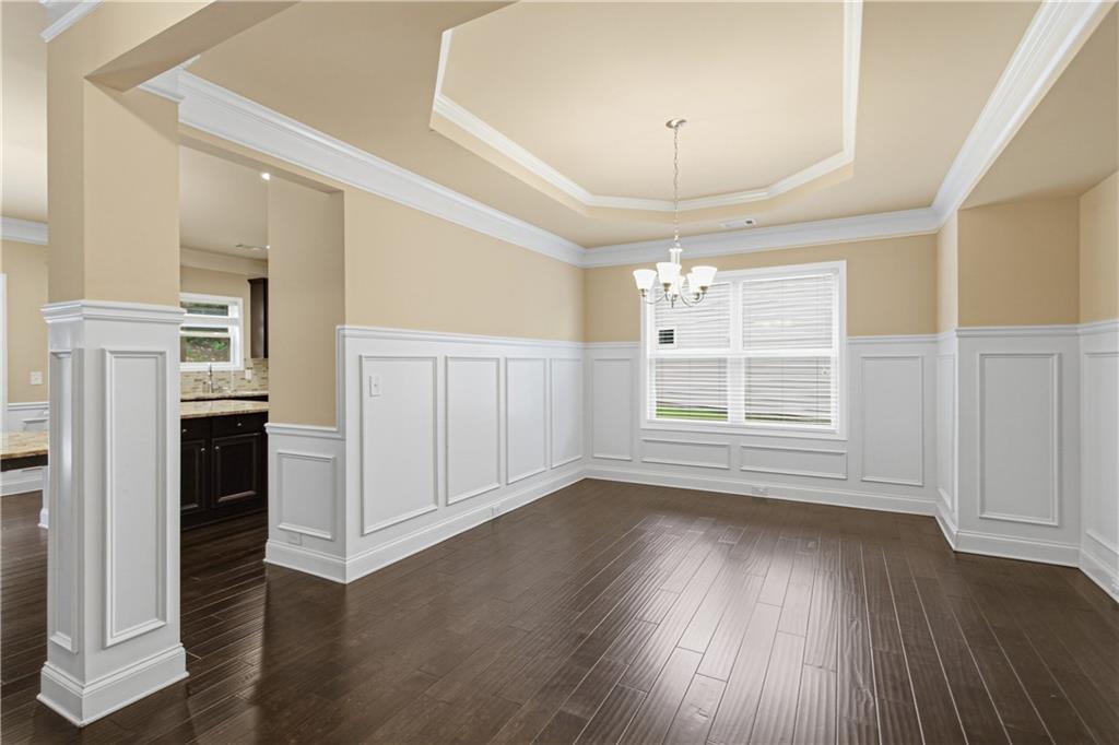 114 Madison Street Canton, GA 30115 - Photo 16 of 39 an empty room with wooden floor fireplace and windows