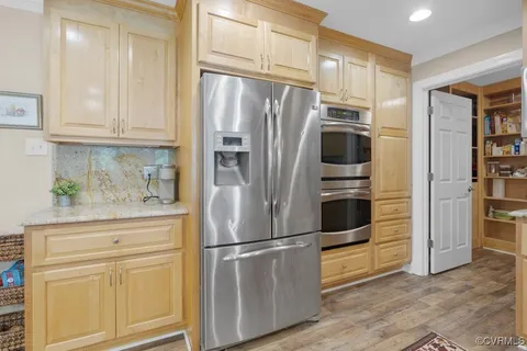 a kitchen with stainless steel appliances a refrigerator stove and cabinets