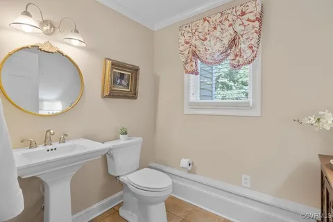 a bathroom with a toilet a sink and a mirror