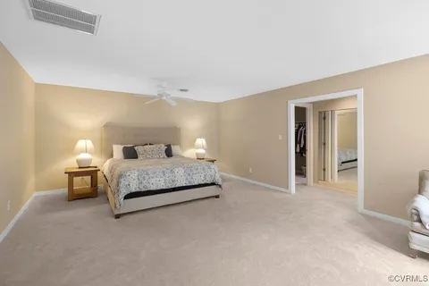 a bedroom with a bed and a lamp