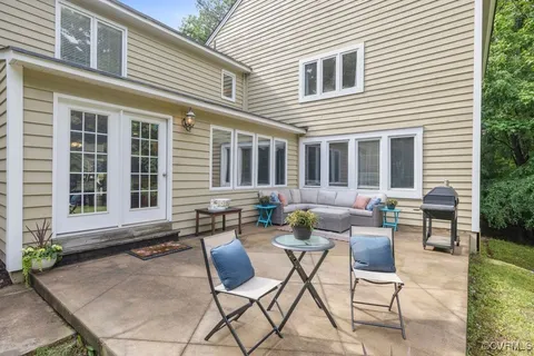 a backyard of a house with outdoor seating
